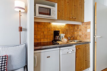 A small kitchen with a microwave and a dishwasher
