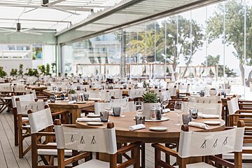 A restaurant with a lot of tables and chairs with the letter a on them