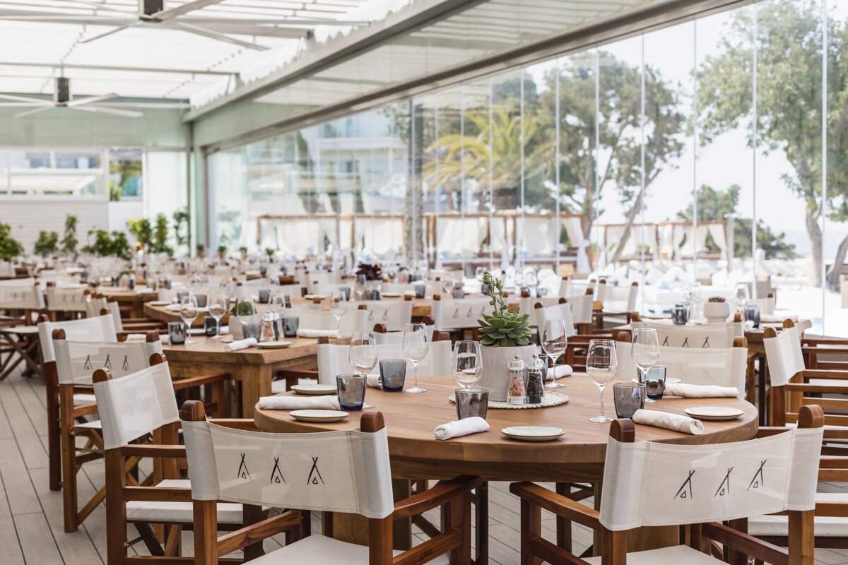 A restaurant with a lot of tables and chairs with the letter a on them