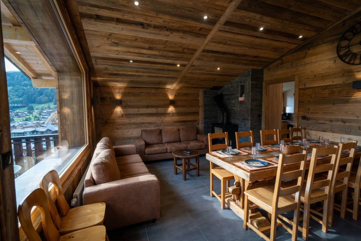 A living room with a couch a table and chairs