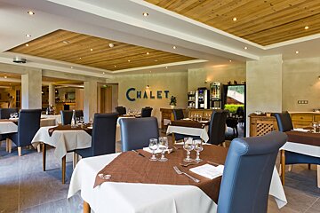 A restaurant with the word chalet on the wall