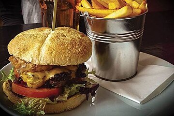 a burger and a pot of chips