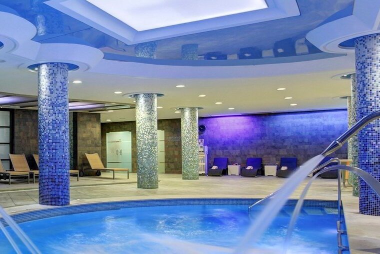 A swimming pool in a spa with a blue ceiling