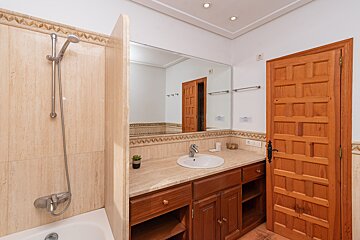 A bathroom with a sink and a large mirror