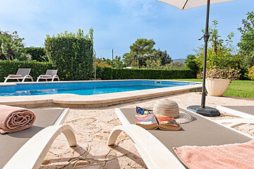 A book on a lounge chair next to a pool