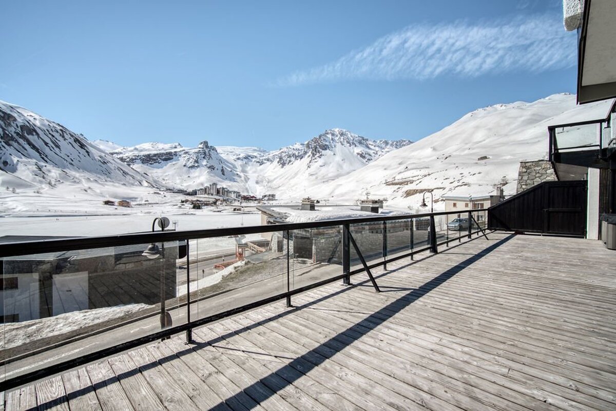 A balcony with a view of snow covered mountains