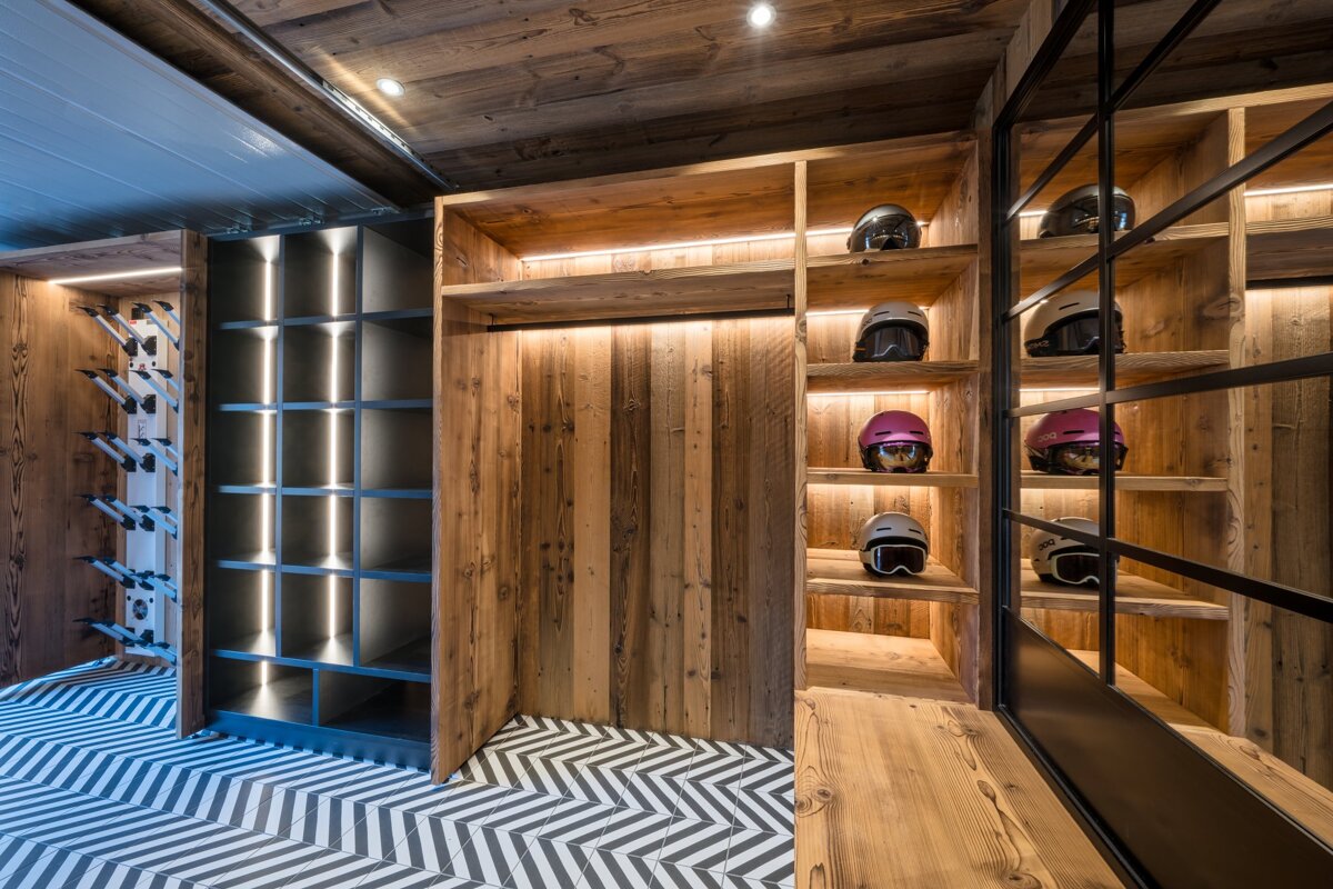 A room with wooden shelves and a chevron floor