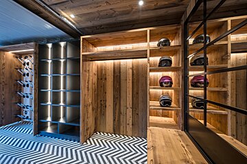 A room with wooden shelves and a chevron floor