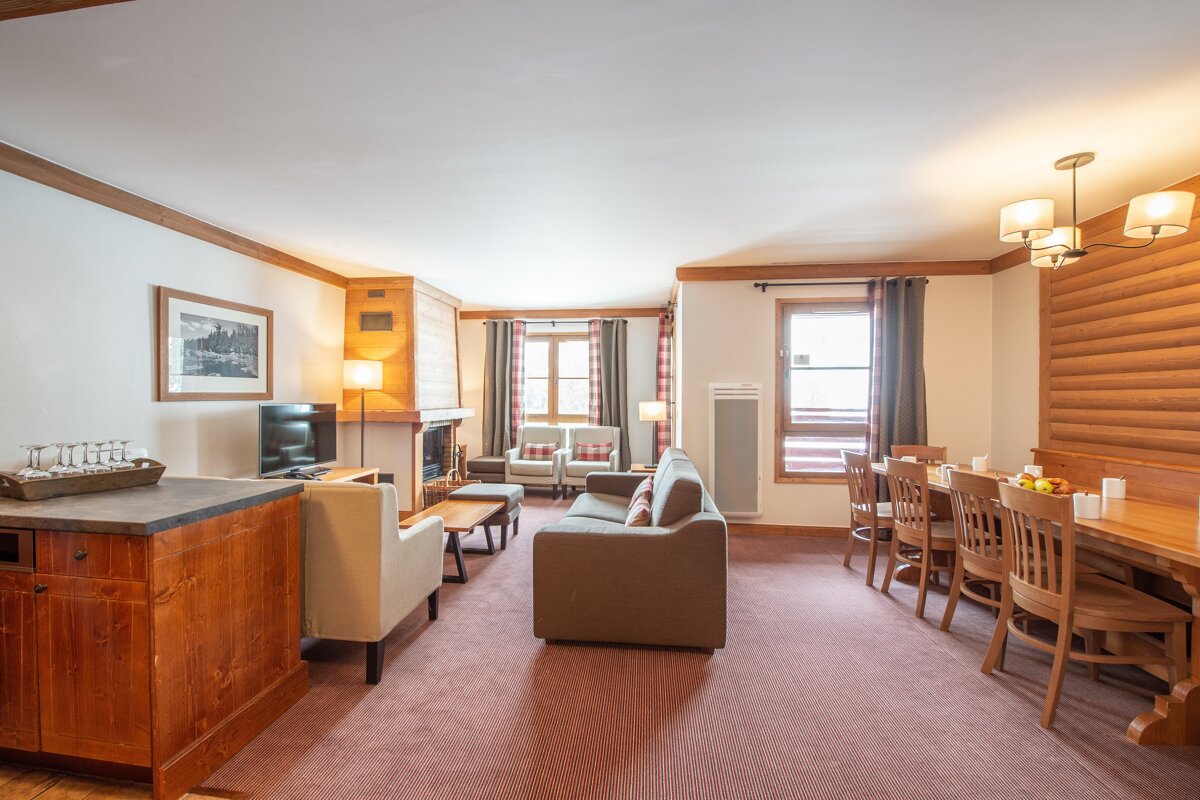 A living room with a couch a chair and a television