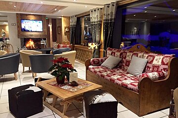 A living room with a couch and chairs and a fireplace