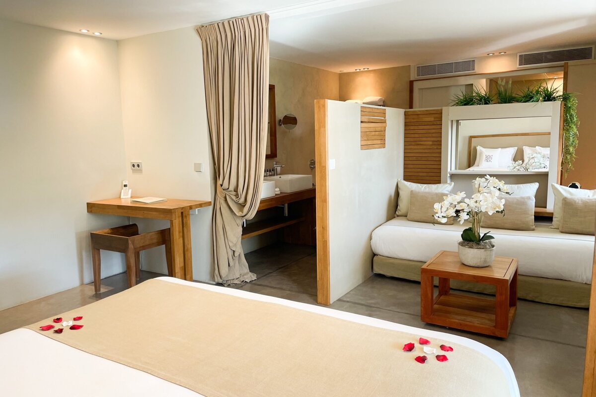 A bedroom with a couch and a sink in it