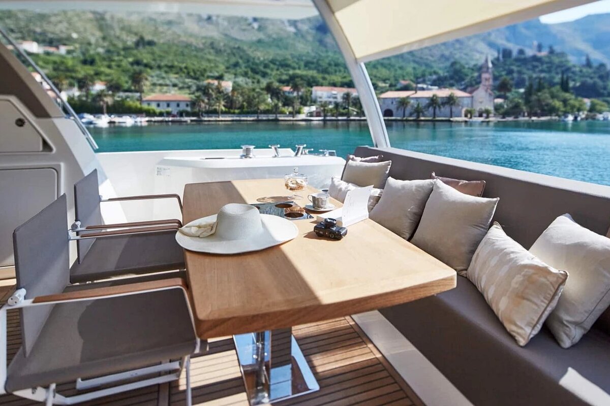 A table with a hat on it sits on the deck of a boat