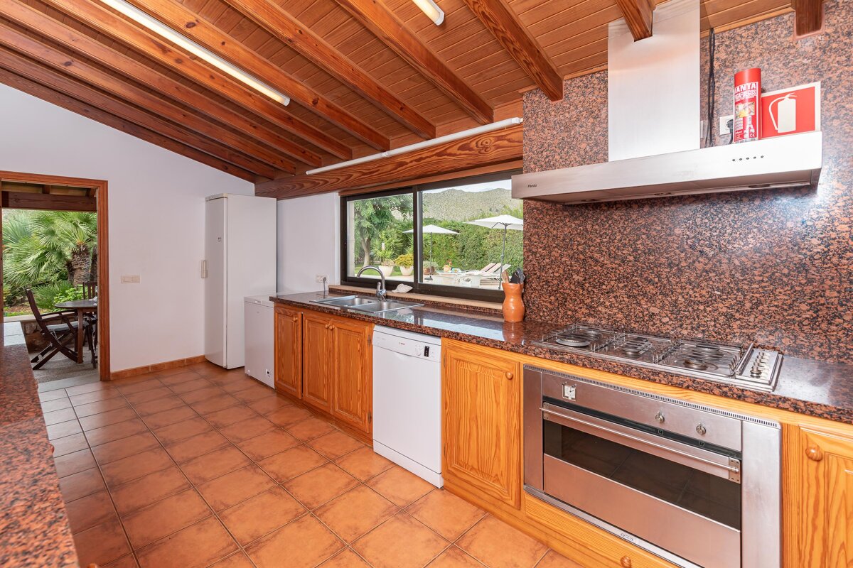 A kitchen with a fire extinguisher on the counter