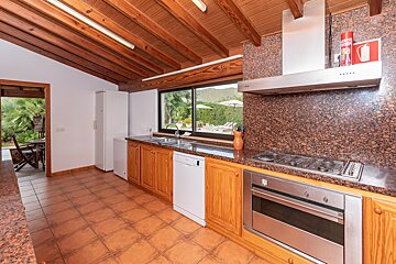 A kitchen with a fire extinguisher on the counter
