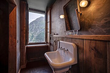 A bathroom with a sink a mirror and a window