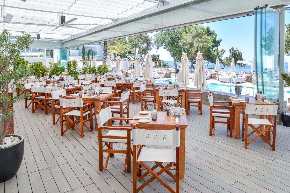 A restaurant with tables and chairs with the letters aaa on them