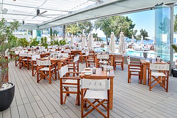 A restaurant with tables and chairs with the letters aaa on them