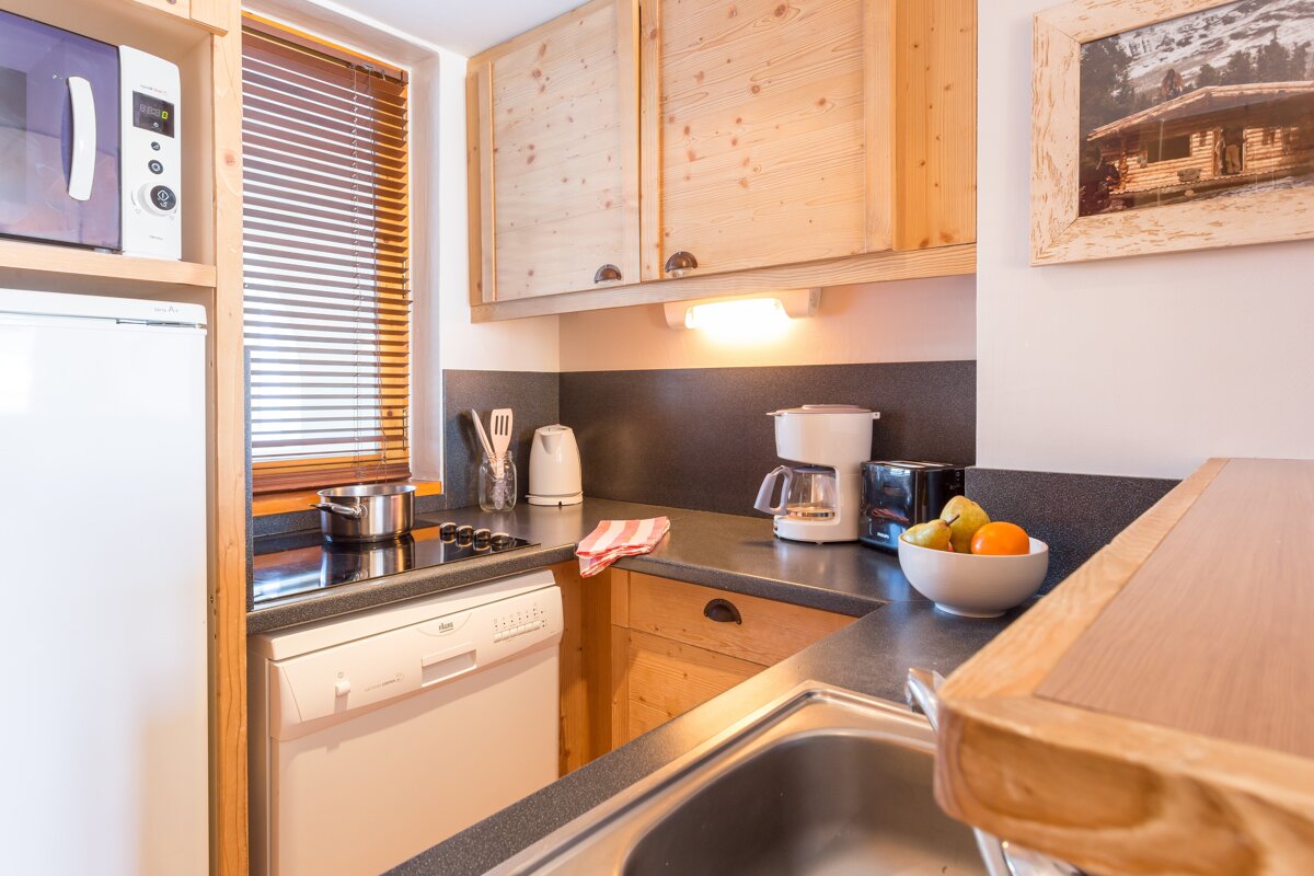 A kitchen with a dishwasher and a coffee maker