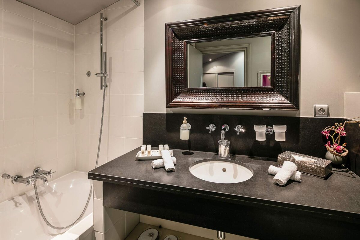 A bathroom with a sink and a large mirror