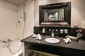 A bathroom with a sink and a large mirror