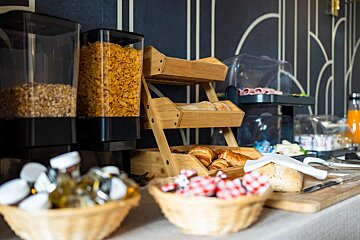A buffet table with cereal and bread on it