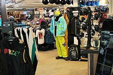 A oakley shirt hangs on a rack in a store