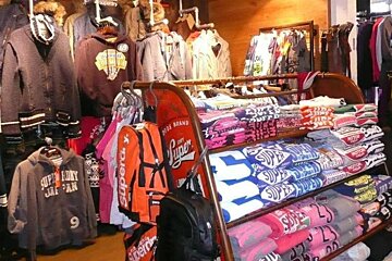 A display of superdry shirts and jackets in a store
