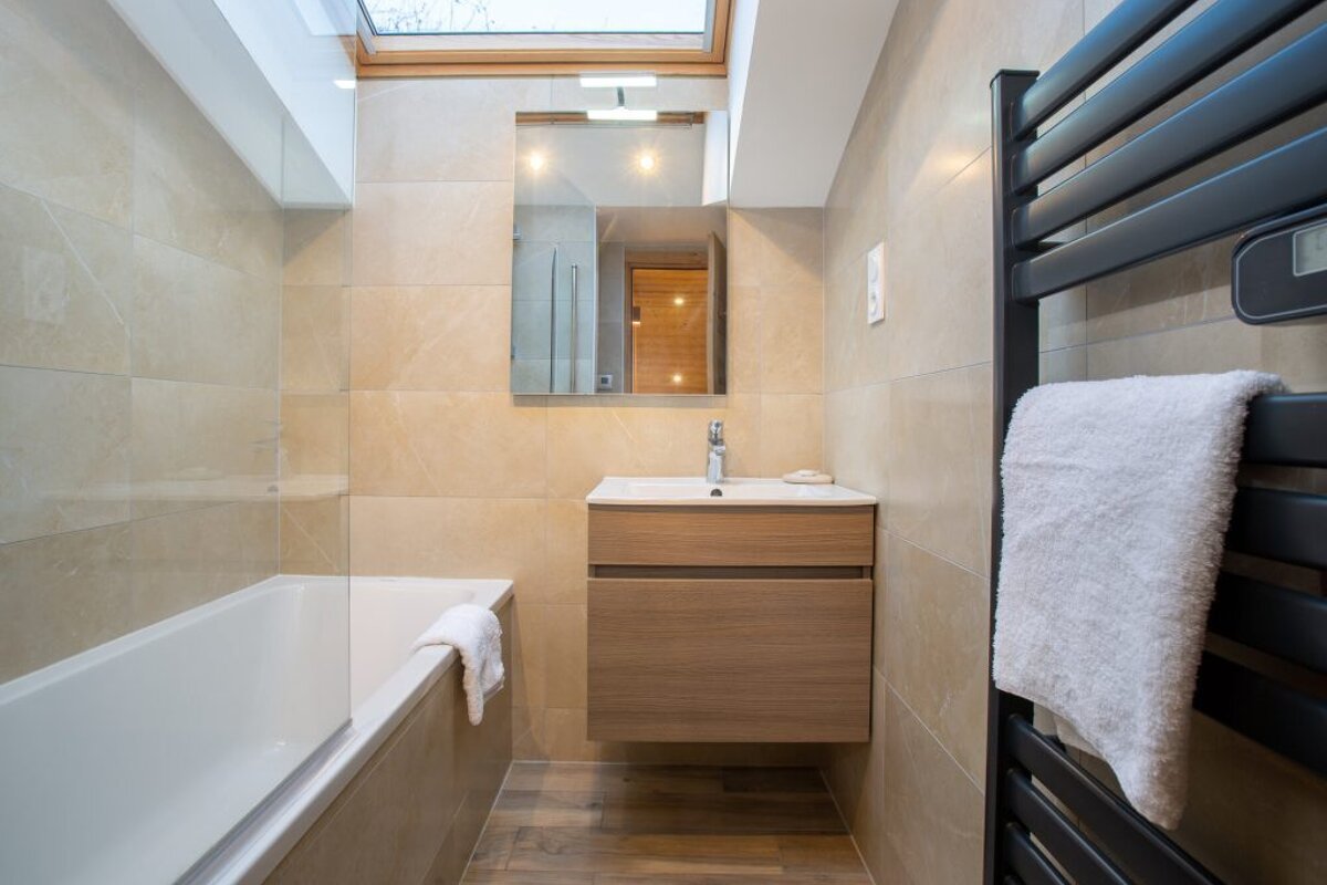 A bathroom with a skylight above the sink