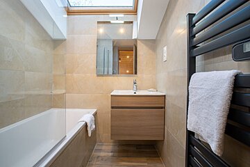A bathroom with a skylight above the sink