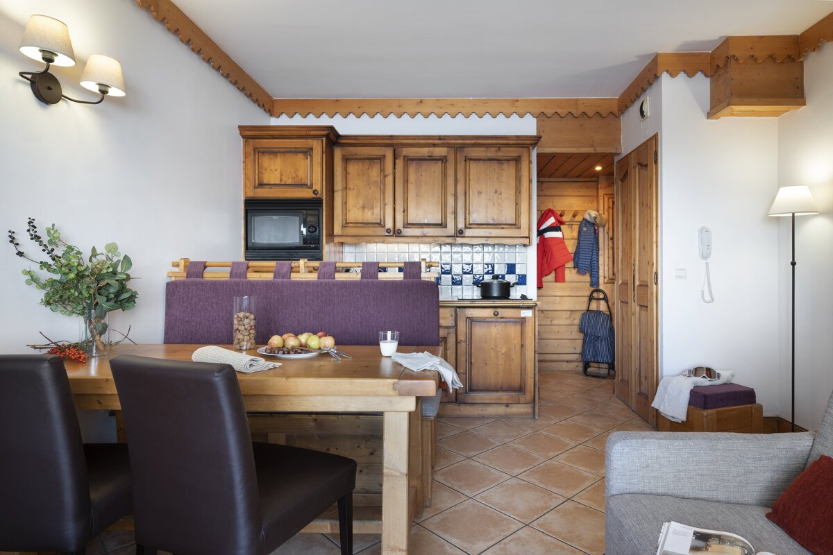A living room with a dining table and chairs