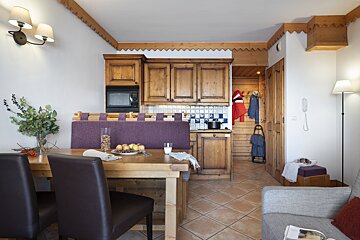 A living room with a dining table and chairs
