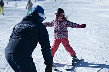 A person wearing a jacket that says supreme on it