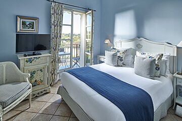 A bedroom with a large bed and a television