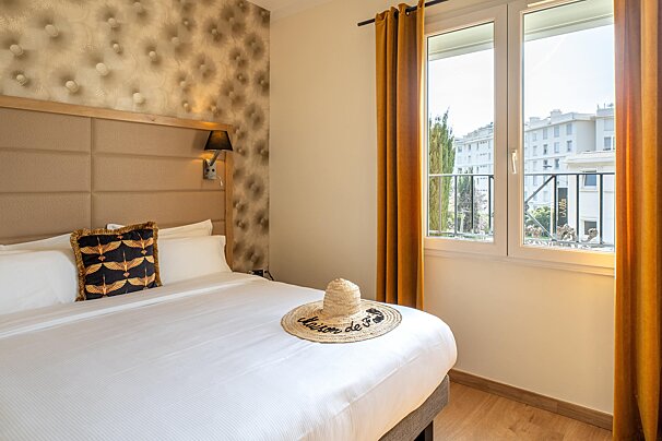 A bed with a hat that says maison on it