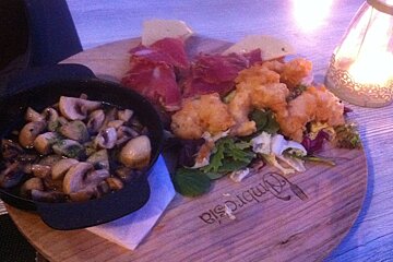 tapas on a wooden board in a restaurant