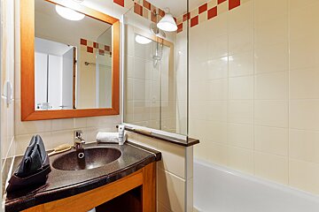 A bathroom with a sink a mirror and a bathtub