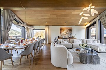 A large living room with a dining table and chairs
