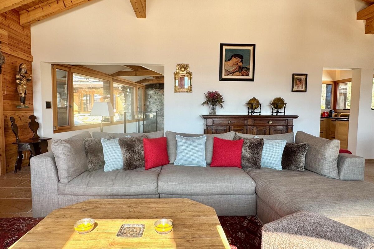 A living room with a couch and a picture on the wall