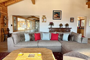 A living room with a couch and a picture on the wall