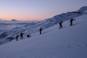 A group of people skiing down a snowy mountain
