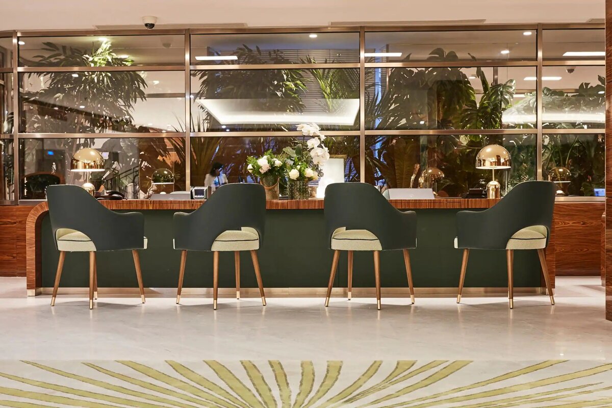 A row of chairs in front of a green counter