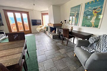 A living room with a fireplace and two posters one of which says chan