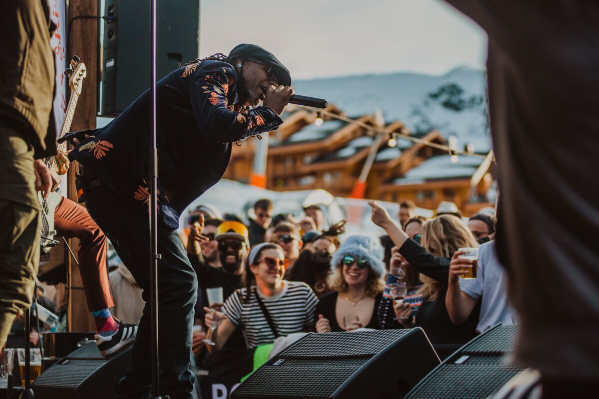 A man singing into a microphone in front of a crowd