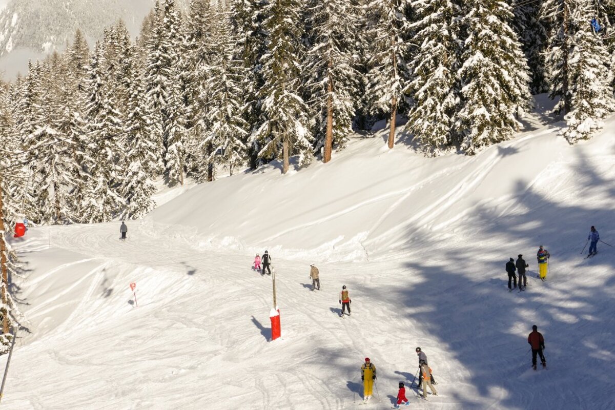 skiers under a chair in les arcs