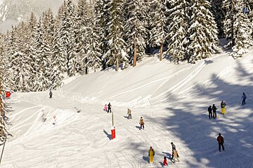 skiers under a chair in les arcs