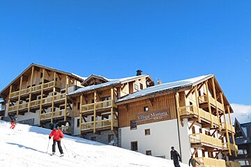 A building with a sign that says village montana on it