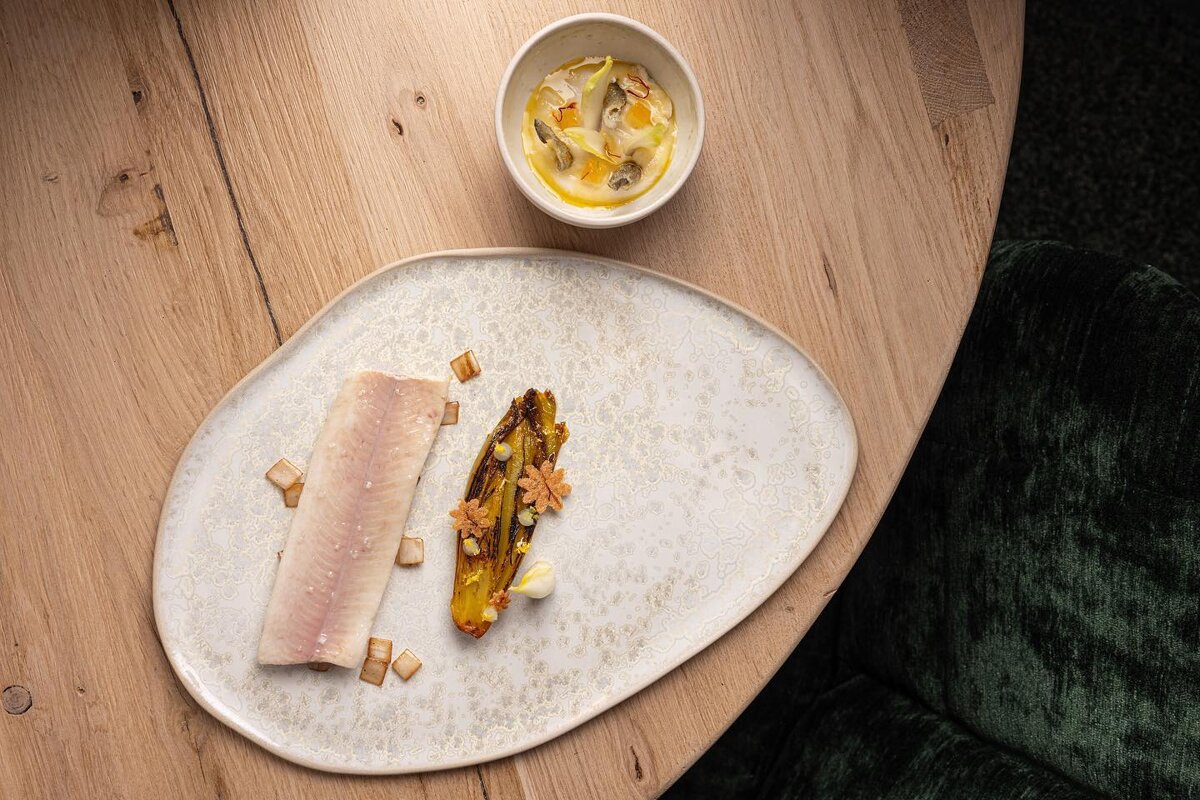 Fish dish plated on a table at Alpage restaurant Courchevel