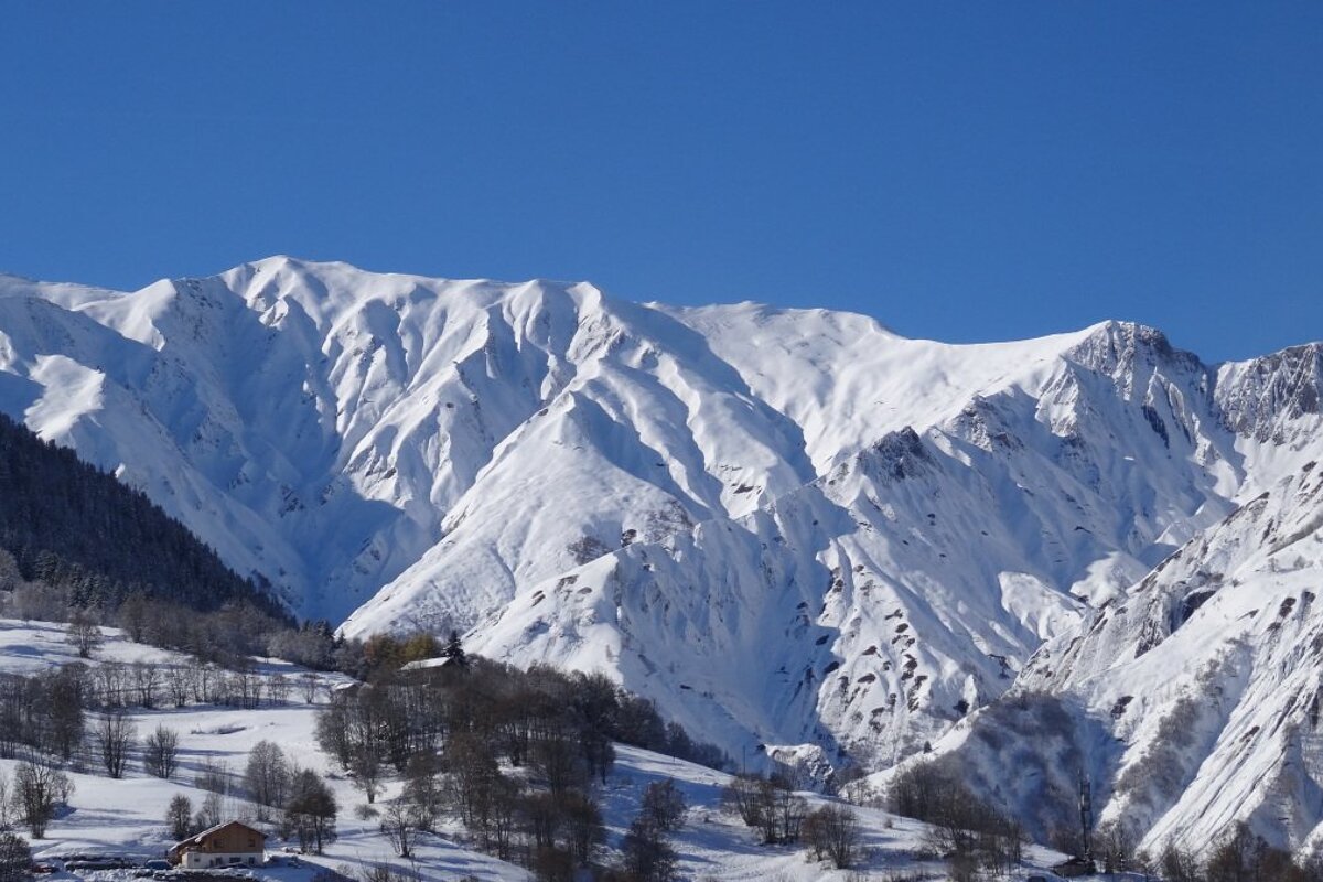 blue skies over snowy mountains