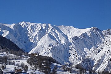 blue skies over snowy mountains