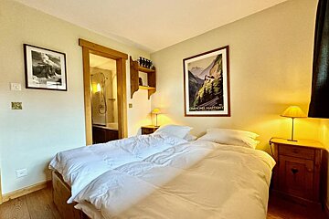 A bedroom with a picture on the wall that says 